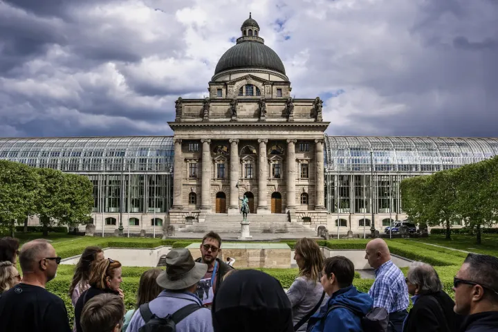 a group of people standing in front of a large building
