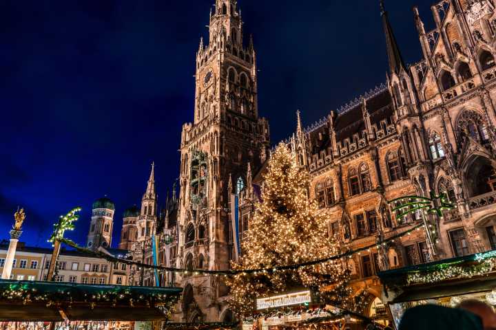 a large clock tower towering over the city of london with New Town Hall in the background