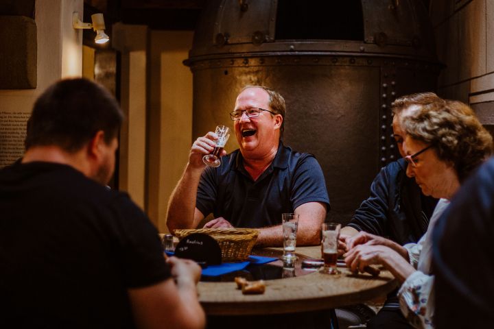 a man sitting at a table eating cake