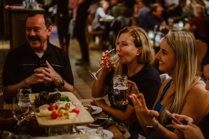 a man and a woman sitting at a table with wine glasses
