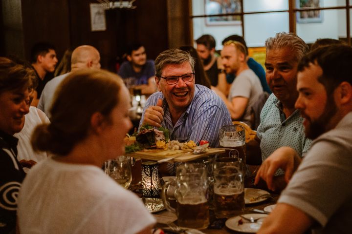 a group of people sitting at a table in a restaurant