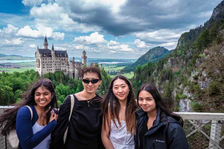 Zoe Leung et al. posing for a photo in front of a mountain