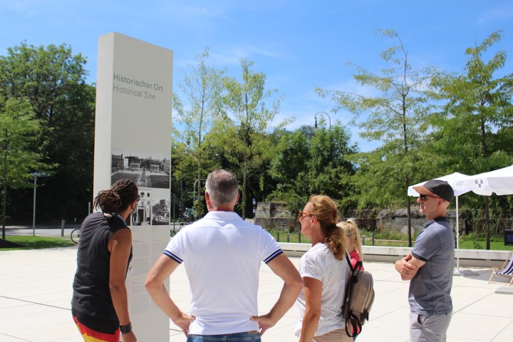 a group of people standing in a parking lot